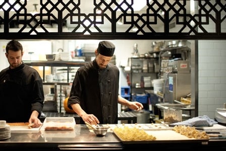 Chefs putting some sweet sanafir into a dish